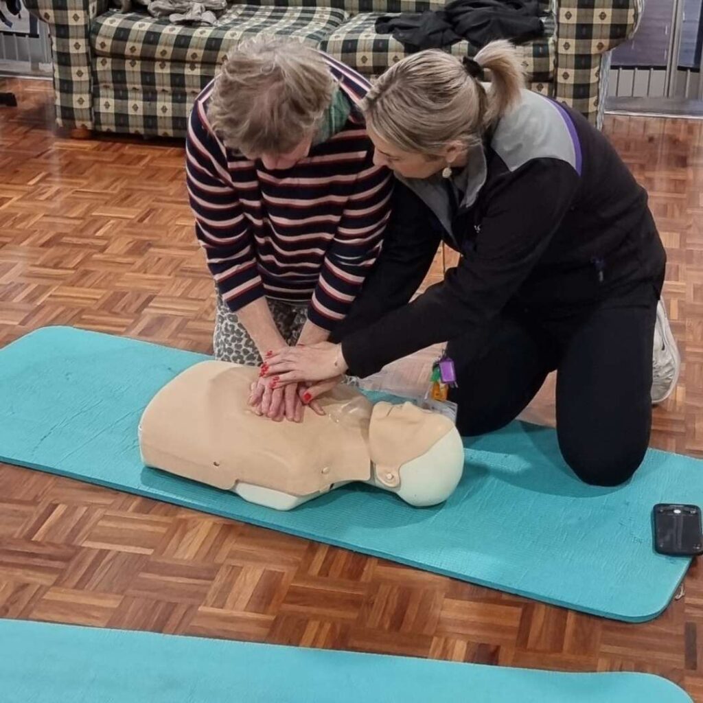Lilac participants learning CPR skills. -